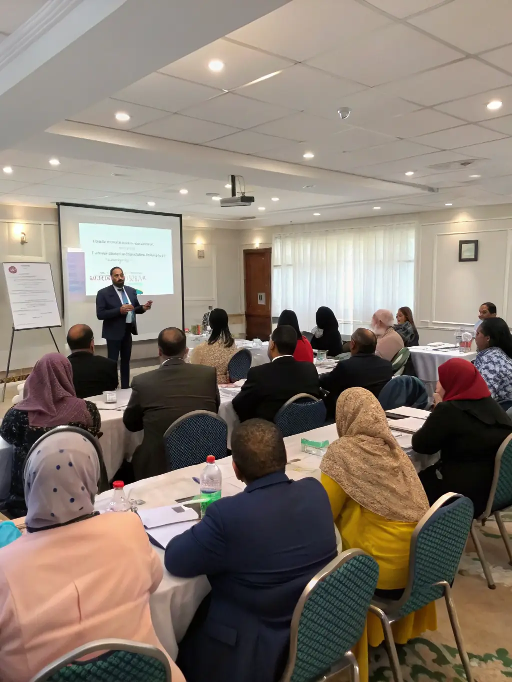 A diverse group of professionals participating in a leadership workshop in a modern office setting in Johannesburg, South Africa, focusing on team building and strategic planning.